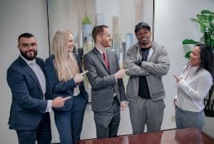 Spolin Law attorneys Matthew Barhoma, Caitlin Dukes, and Aaron Spolin celebrate with client R.H. and case manager Hemi Tann
