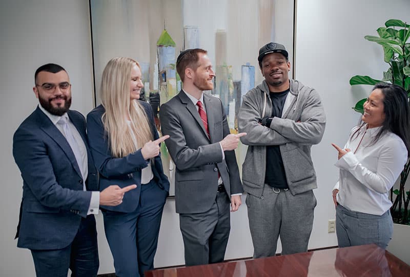 Spolin Law attorneys Matthew Barhoma, Caitlin Dukes, and Aaron Spolin celebrate with client R.H. and case manager Hemi Tann